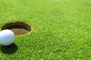 golf ball on lip of cup golf ball on lip of cup close up